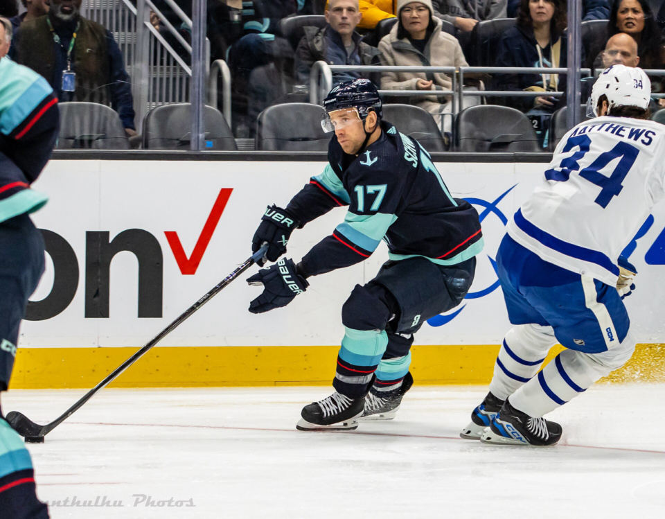 Auston Matthews of the Maple Leafs battles Seattle's Jaden Schwartz in a January 2024 game